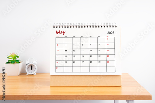 May 2026, Monthly desk calendar for 2026 year on wooden table.