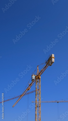 Single Tower Crane With Wide Blue Sky and Copy Space