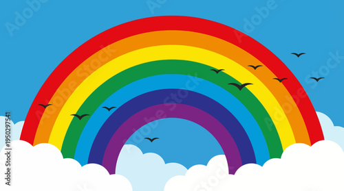 Vibrant rainbow arching across a clear blue sky with fluffy white clouds and several birds flying.