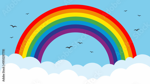 A colorful rainbow with red, orange, yellow, green, blue, indigo, and violet bands arches over fluffy white clouds in a bright blue sky with flying birds.