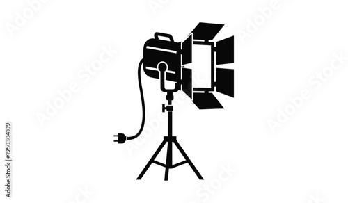 Professional film studio spotlight equipment with four barn doors mounted on a sturdy tripod stand
