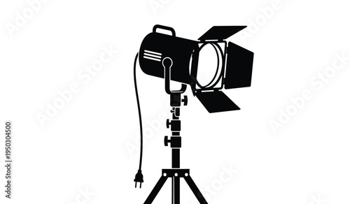 Professional studio spotlight equipment mounted on an adjustable metal tripod stand for lighting