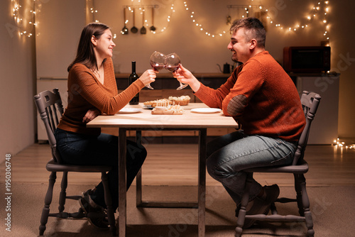 Couple In Love During Romantic Dinner Toasting with Red Wine at Home