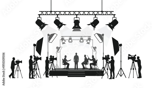 Silhouettes of a film production crew working on a professional stage with lighting and cameras