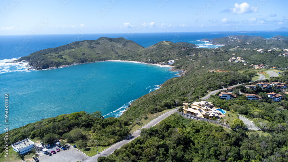 Obraz premium Drone view of João Fernandes neighborhood in Búzios with Praia Grande and cruise ship in turquoise ocean – tropical coastal scenery and seaside tourism