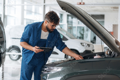 Wallpaper Mural Hood is opened. Auto service specialist examining vehicle condition Torontodigital.ca