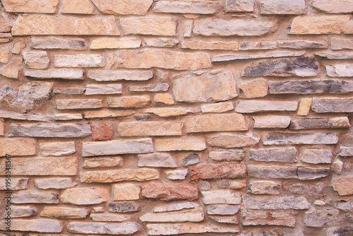 The beige sandstone brick masonry wall texture rustic old background facade