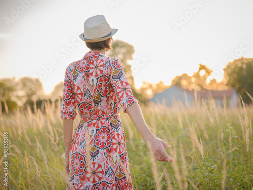 boho chic woman in a floral dress in European countryside