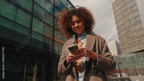 Professional Woman Checks Phone In City Setting