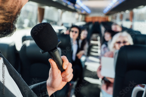Tour guide speaks to group on the bus during a city exploration trip