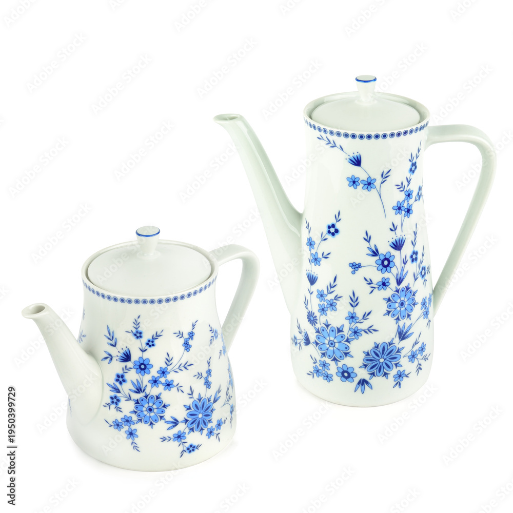 Fototapeta premium Elegant white ceramic teapot and coffee pot set with blue floral pattern isolated on white background. Vintage porcelain tea set with floral ornament. Classic kitchenware for tea party.