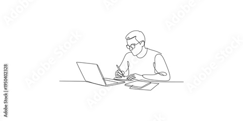 Man sitting at a desk working on laptop and writing on notepad person adult male