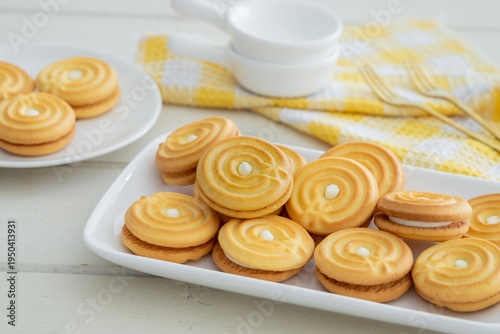 Sandwich cookies with vanilla cream on white plate