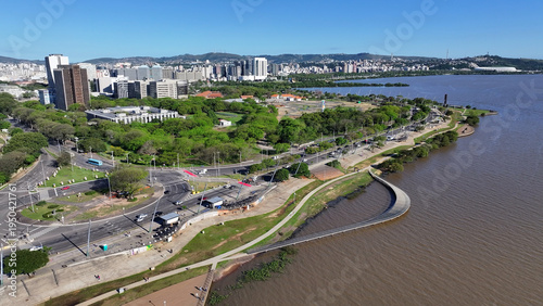 Edge Of Guaiba In Porto Alegre Rio Grande Do Sul Brazil. Turquoise Ocean Waves Gently Crashing On Tropical Beach. Business Sky Background Downtown Cityscape. Outdoor Downtown Panning Wide.