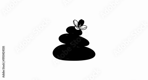 Black balanced stones with a white flower on top