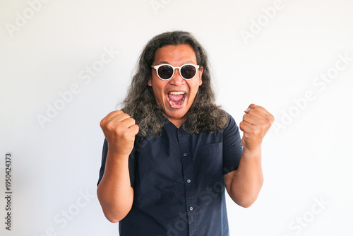 Photography Adult man showing happy expression and standing in front of white isolated wall