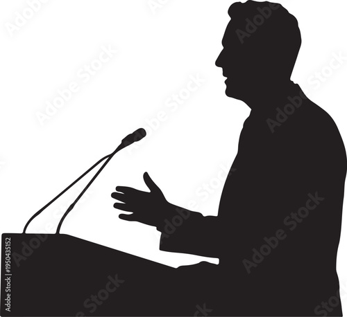 Silhouette of a man speaking at a podium with a microphone