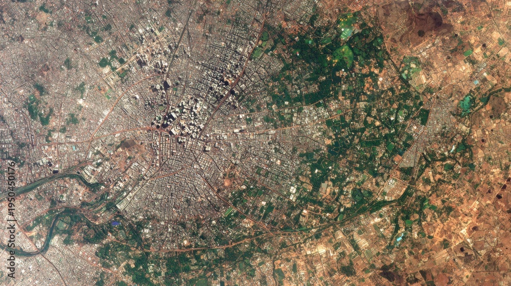 Obraz premium Aerial view of dense urban sprawl and agricultural fields