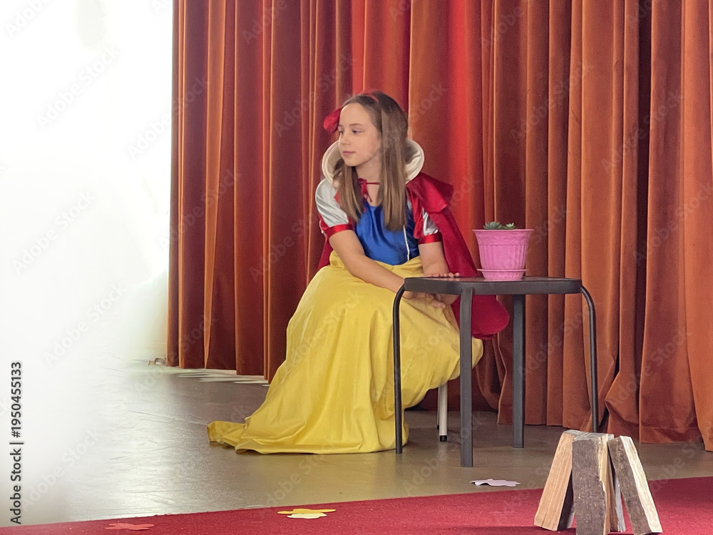 Fototapeta premium The Snow White fairy tale performance. Cute little actress in school theatre