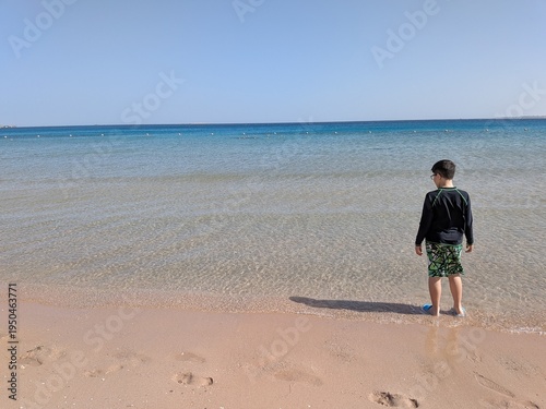 Boy walking on the beach Sahl Hasheesh Red Sea Egypt