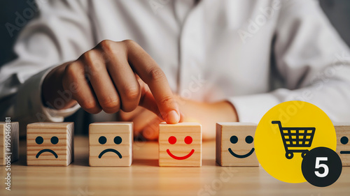 A hand choosing a happy face on a wooden block