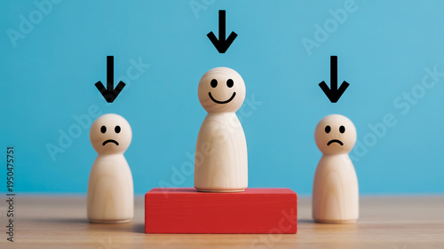 Three wooden figures with different emotions on a table