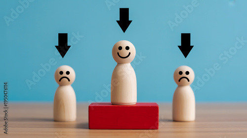 A wooden figure on a red block with two frowning figures on either side