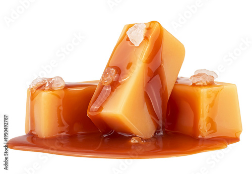 Caramel candies topped with melted caramel sauce and sea salt crystals isolated on a white background