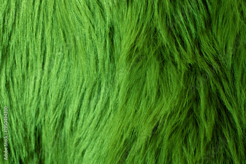 Green fluffy faux fur surface texture macro background
