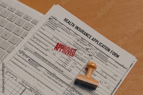 Photos Health insurance application form with red approved stamp on office desk, financial planning concept