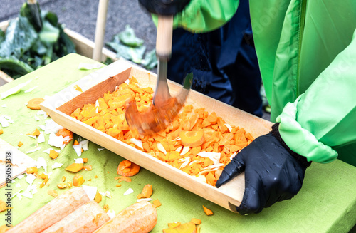 Chopping carrots in a wooden trough to make kroshevo
