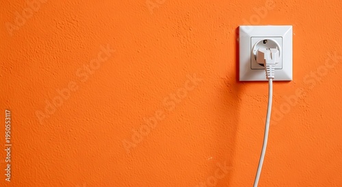 White Electrical Outlet with Cord on Orange Wall.