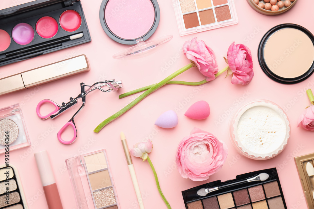Fototapeta premium Spring composition with different makeup products and flowers on pink background, flat lay