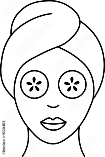 A face with a cucumber mask and towel