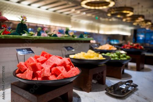 Fotografija Hotel buffet station featuring sliced watermelon, pineapple, and other fresh fru