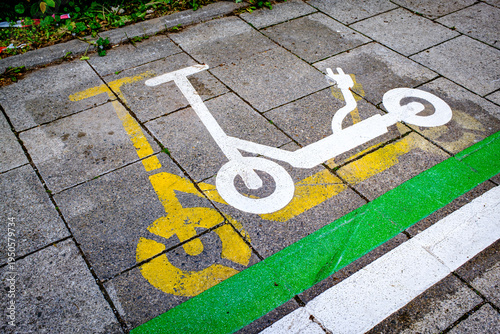 Parking space marked for electric scooters on a sidewalk in a busy urban area during daylight hours