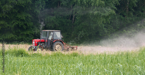 Agricultural tractor working in a field during harvest