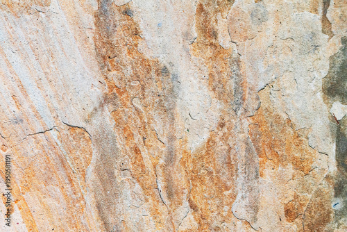 Closeup natural sandstone texture with layered erosion marks and mineral streak patterns