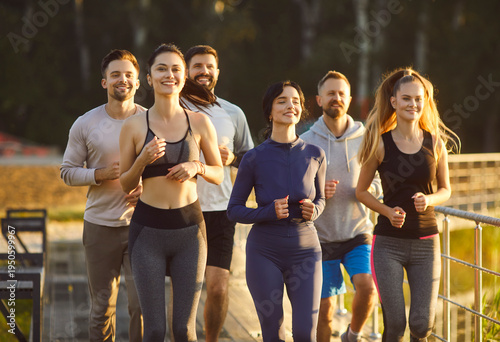 Athlete runners team jogs together during outdoor training, enhancing group sport, building fitness through running, connecting members in synchronized group workout and jogging across a open terrain.