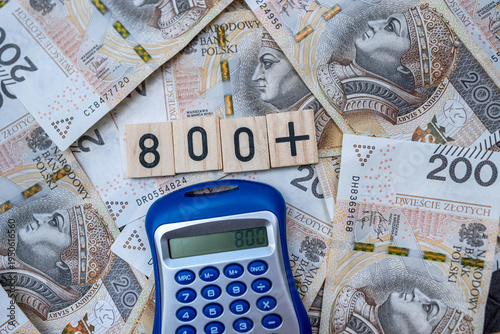 800 Polish zloty banknotes with wooden tiles showing eight hundred plus and a blue calculator