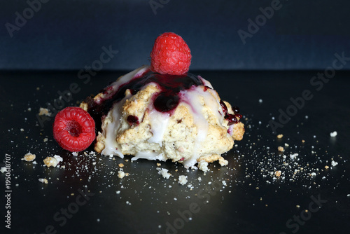 Scones with raspberry jam and lemon glaze on top