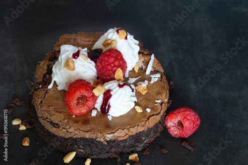 Delicious American Brownie with whipped cream and fresh raspberries