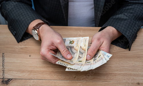 Wallpaper Mural Close up of Man in Suit Counting Polish Zloty Currency for Mortgage Loan or Personal Savings Torontodigital.ca