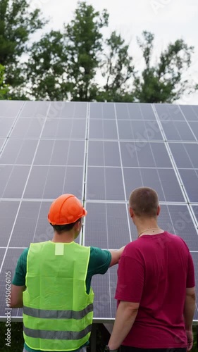 An engineer explains to a client how solar panels work. High quality 4k footage