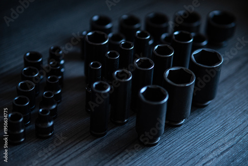 Картината върху платно High-performance impact sockets dominate the foreground, showcasing their precision 6-point (hexagonal) broaching and heavy-duty side walls