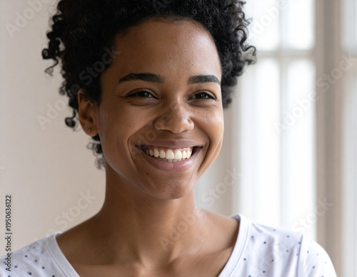 realistic close-up portrait of a young smiling woman.