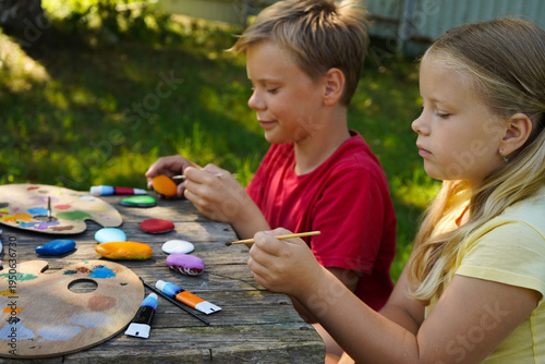 Children find canvas in nature, painting rocks with playful designs to give as their own handmade keepsakes.