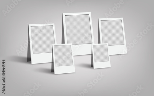 Empty white polaroid photo frame templates standing on grey background for instant photography mockups and creative portfolio displays for presentation