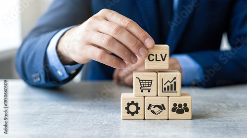 Businessman building a pyramid of wooden blocks with clv customer lifetime value icons and symbols