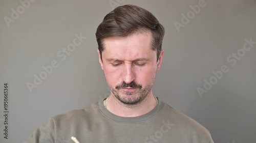 A man sniffs a container of sushi rolls and winces at the unpleasant odor. A young woman tastes the spoiled food and spits it back out